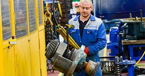 Engineer moving gearbox with overhead crane