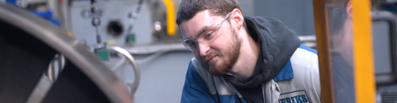 Close up of an Engineer working in a workshop wearing googles