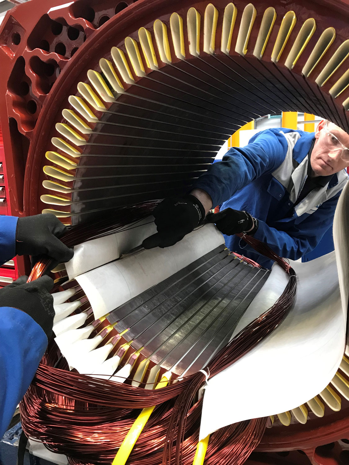 ERIKS engineers working on large electric motor coil