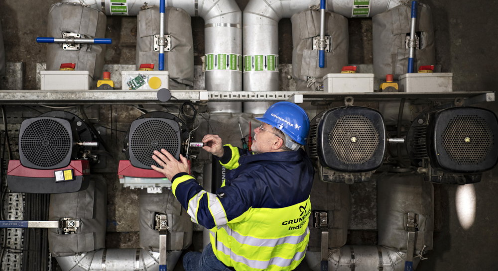 Grundfos worker fixing steam level on boiler feed