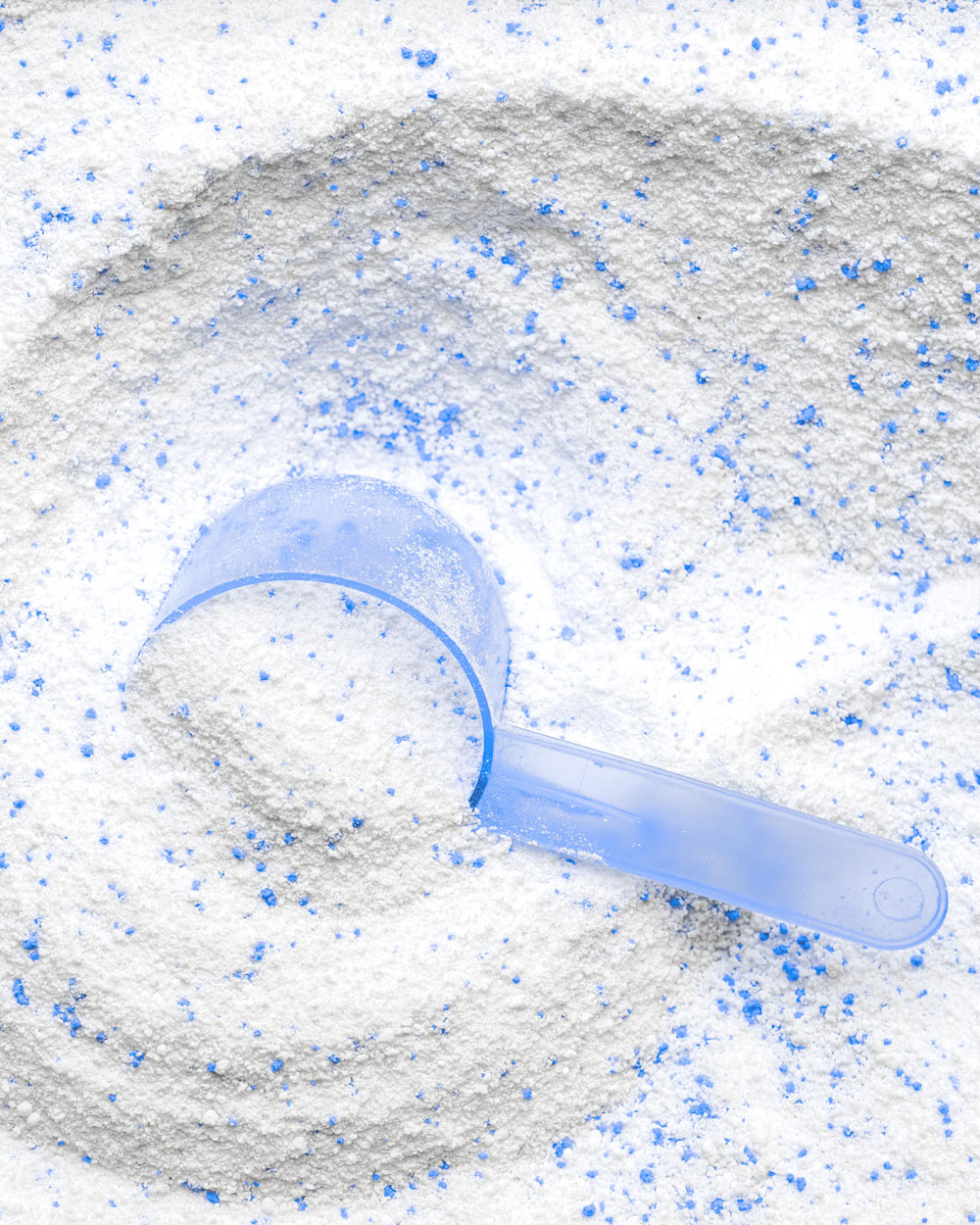 Detergent powder. White wash soap texture with cup for laundry background. Liquid soap in scoop for machine. Housekeeping and household, domestic housework cleaning service concept.