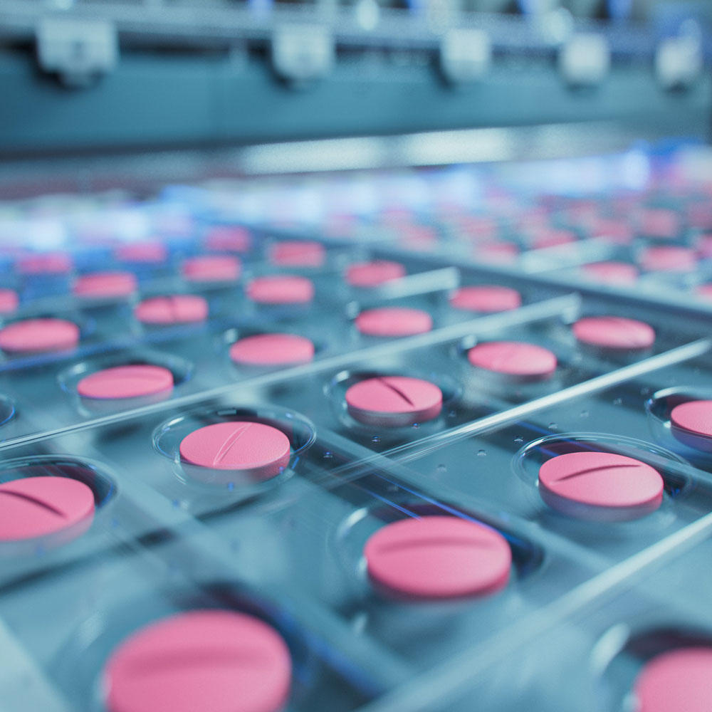pink pills on a production line