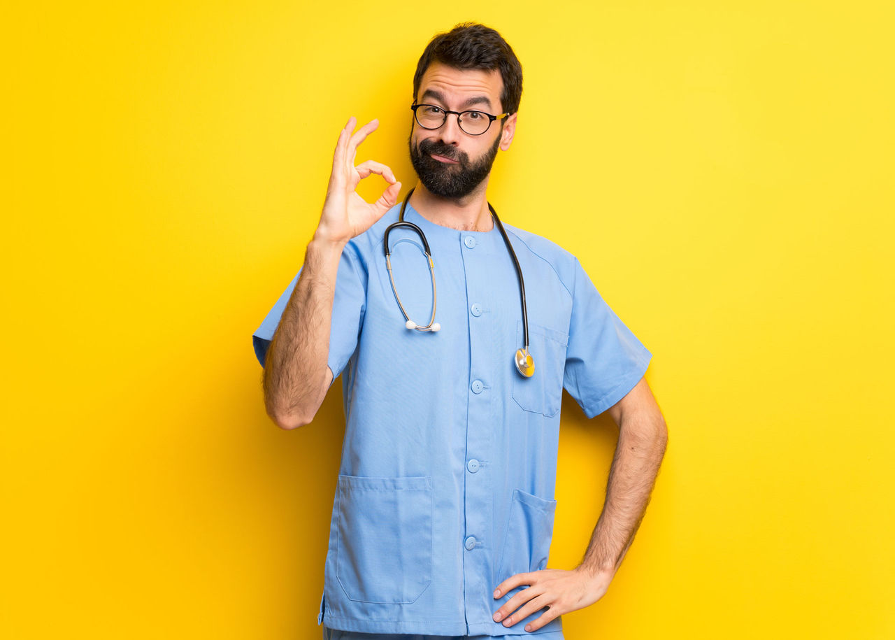 Surgeon doctor man showing an ok sign with fingers