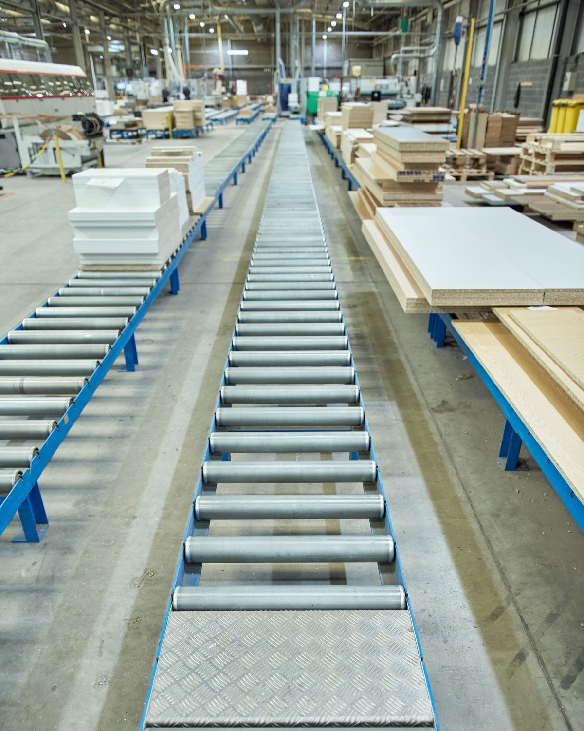 An empty industrial roller conveyor belt in a fully automated factory. roller conveyor to easily move heavy industrial goods around without the need for humans.future of industrial manufacture. Conveyor system used to transport materials