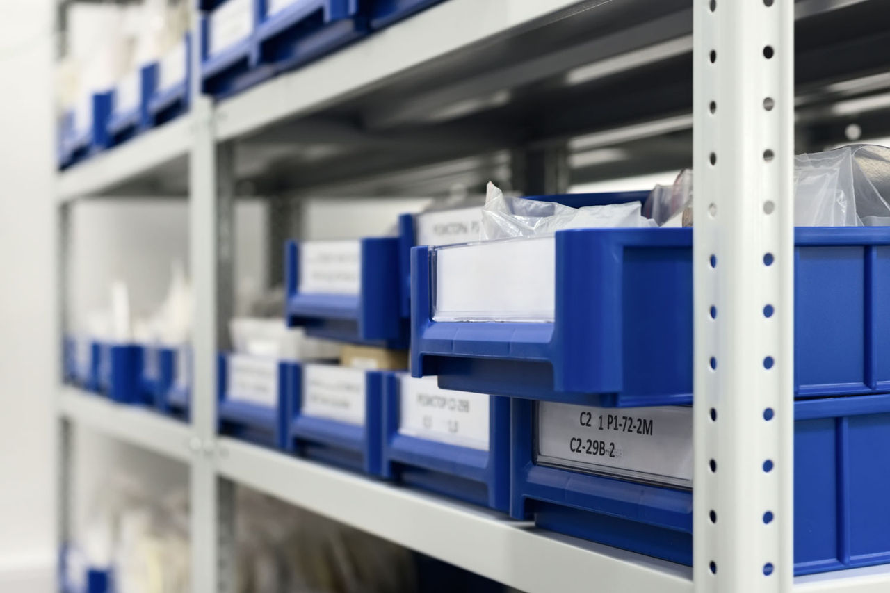 Blue plastic trays in metal racks. Blue plastic trays in metal racks.