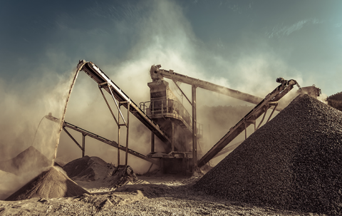 Dramatic landscape photo of a quarry and huge machinery at work